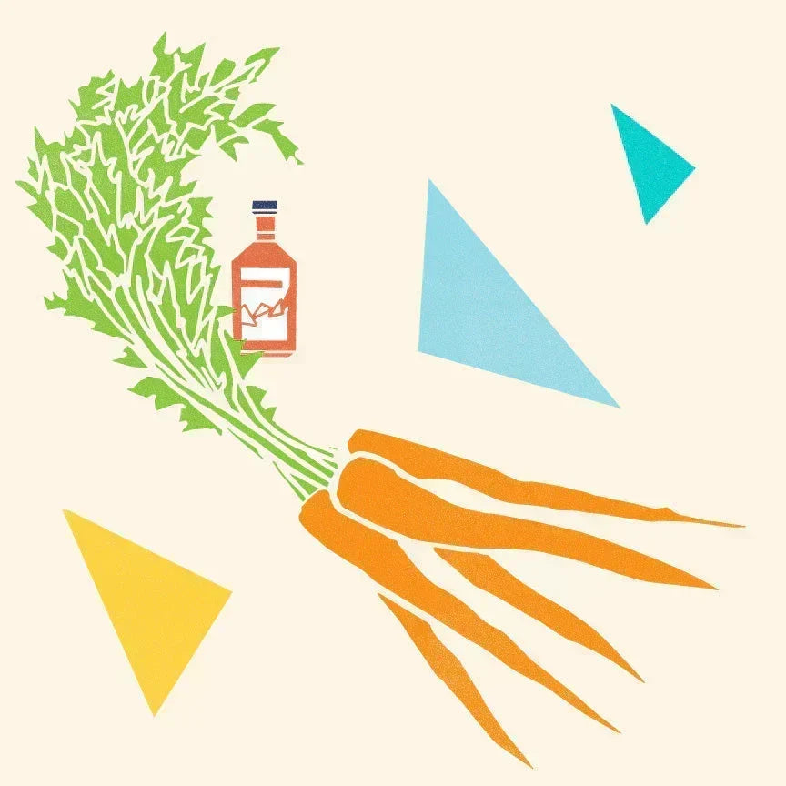Bunch of carrots with leafy greens & small vinegar bottle with geometric shapes on cream background