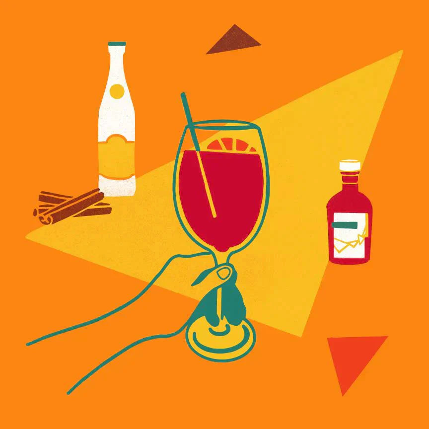 Hand holding red spritz in wine glass with cinnamon, wine and vinegar bottles on orange background