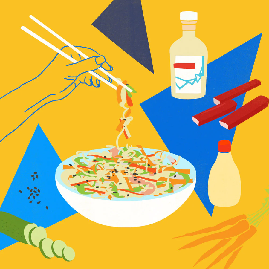 Kani salad lifted with chopsticks on a yellow background with vinegar bottle, imitation crab sticks, cucumber, carrots, and sesame seeds