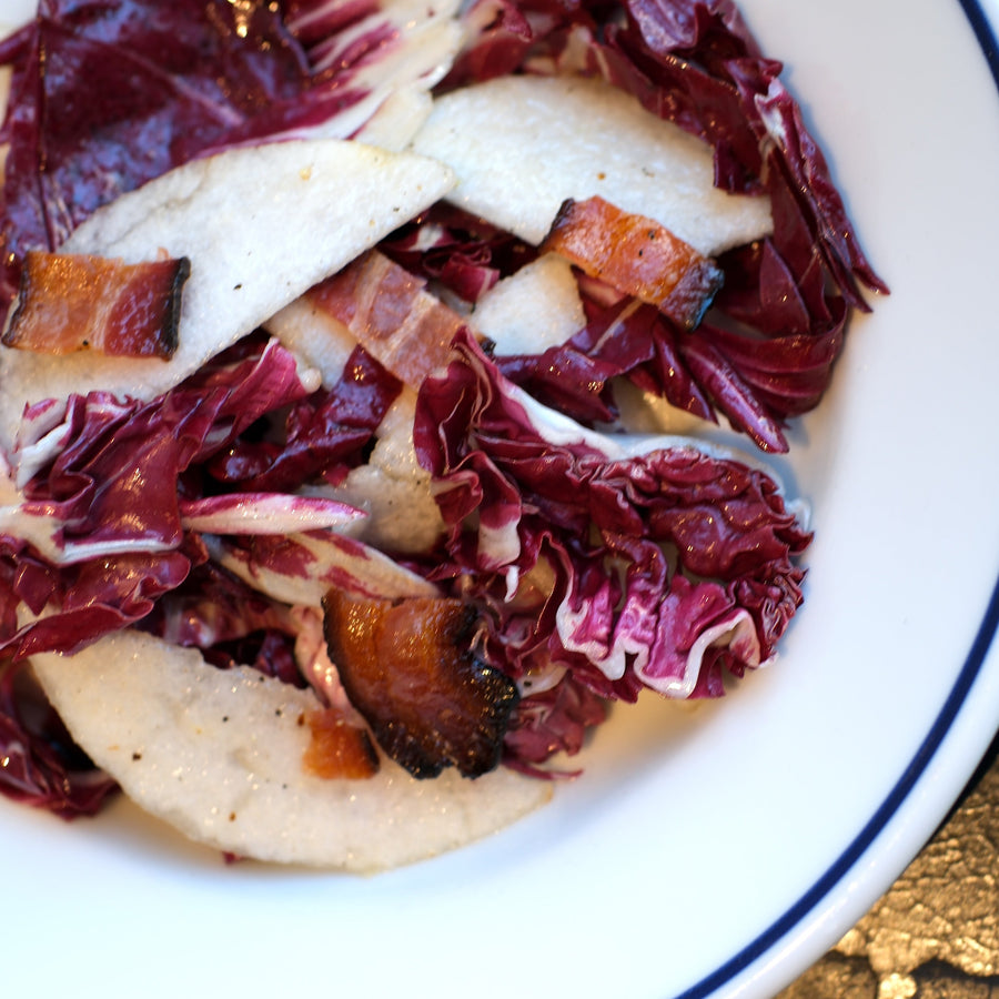 Radicchio and asian pear salad on white plate