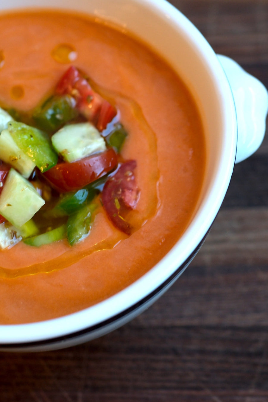 Gazpacho in white bowl on cutting board