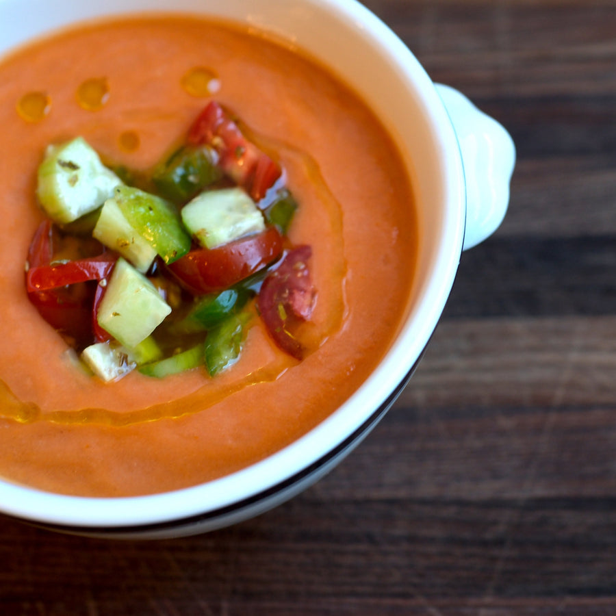 Gazpacho in white bowl on cutting board
