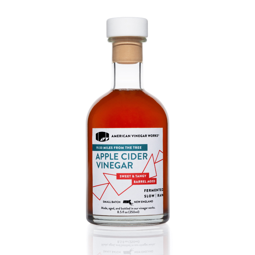 The front view of a bottle of American Vinegar Works Apple Cider Vinegar, featuring a white and red "19.53 Miles From The Tree" label against a clean white background.