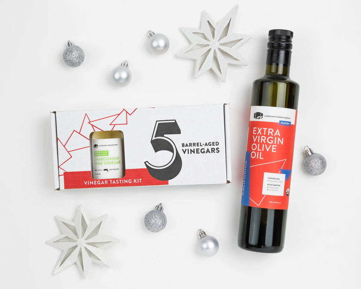 Vinegar Tasting Kit and Olive Oil gift set flat lay with holiday decorations — artisanal gift set