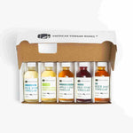 Open gift box with five small vinegars: Rice Wine, Chardonnay, Apple Cider, Red Wine, and Beer Malt.