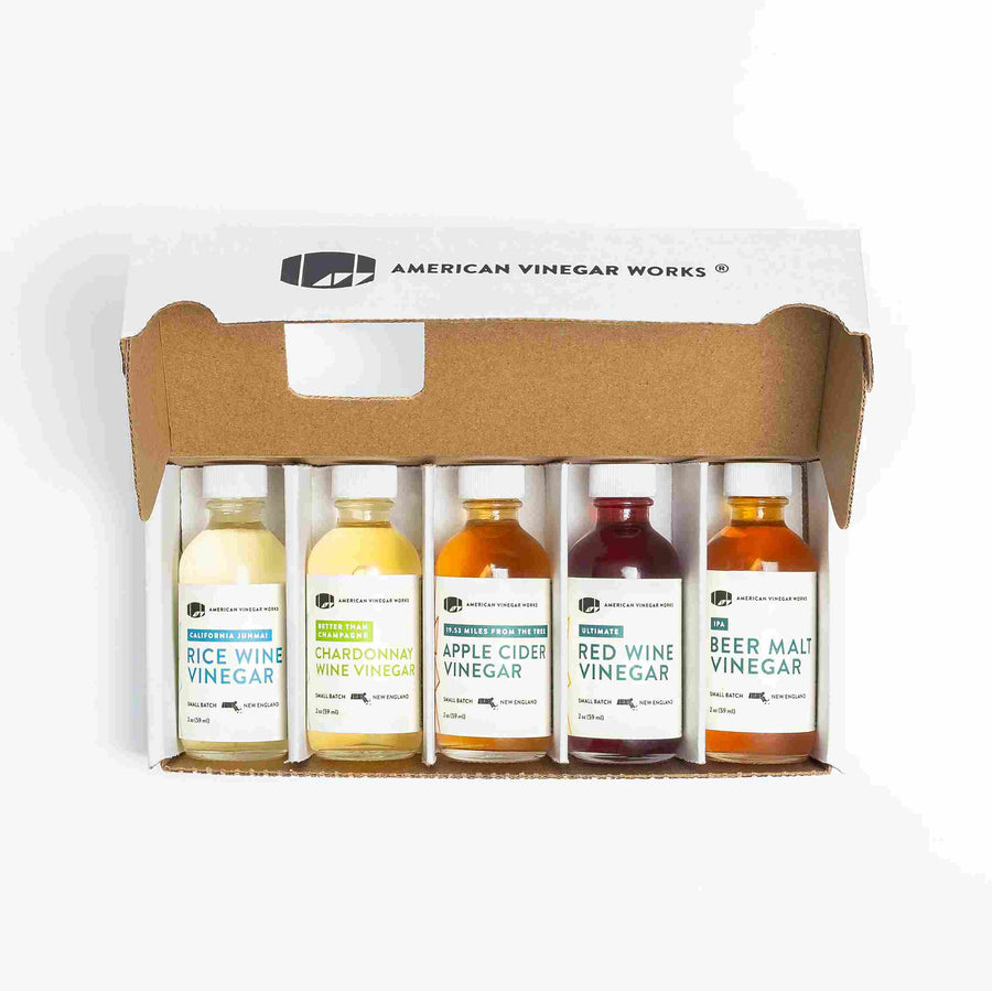 Open gift box with five small vinegars: Rice Wine, Chardonnay, Apple Cider, Red Wine, and Beer Malt.