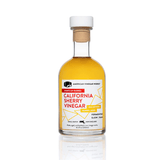 A bottle of American Vinegar Works California Sherry Vinegar with a white cap and yellow-tinted liquid.