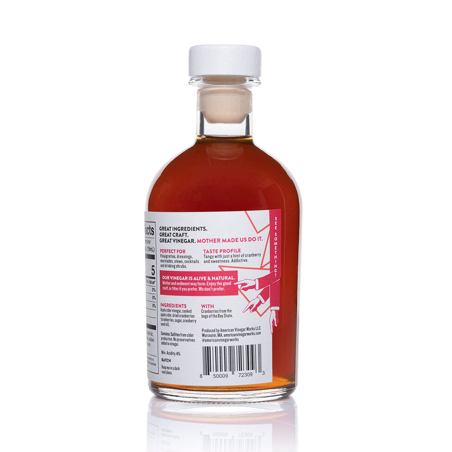 The back label of a bottle of American Vinegar Works Cranberry Apple Cider Vinegar, detailing ingredients, taste profile, and production information.