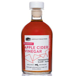 Front view of Cranberry Apple Cider Vinegar: white cap and rich, deep-toned liquid.