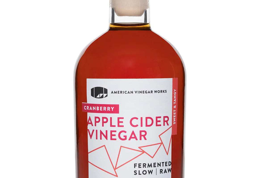 Front view of Cranberry Apple Cider Vinegar: white cap and rich, deep-toned liquid.