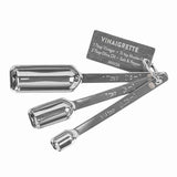 Stainless steel measuring spoons with a recipe tag, marked 1 tbsp, 1 tsp, and 1/4 tsp.