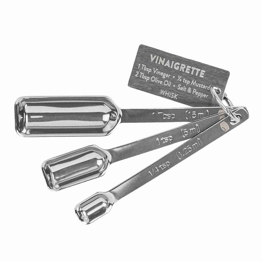 Stainless steel measuring spoons with a recipe tag, marked 1 tbsp, 1 tsp, and 1/4 tsp.