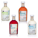 Four bottles of American Vinegar Works vinegars: Chardonnay, Apple Cider, Red Wine, and Rice Wine.