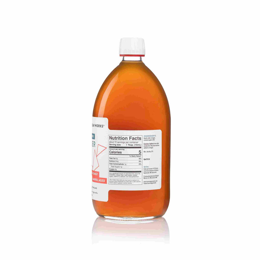 The front view of an 8.5 fluid ounce bottle of American Vinegar Works Apple Cider Vinegar, labeled "19.53 Miles From The Tree," featuring a deep amber liquid and a white label with red accents.