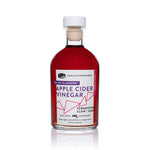 Front view of 8.5oz Blueberry Apple Cider Vinegar: deep red liquid, white/purple/pink label on white