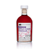 Front view of 8.5oz Blueberry Apple Cider Vinegar: deep red liquid, white/purple/pink label on white