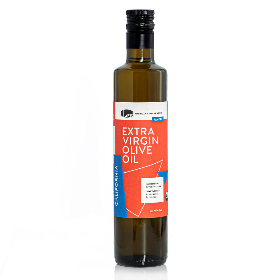 A 500ml bottle of American Vinegar Works California Organic Extra Virgin Olive Oil, a cold-pressed finishing oil crafted from Arbequina and Koroneiki olives.