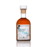 Front view of IPA Beer Malt Vinegar: white and blue barrel-aged label against a white background.