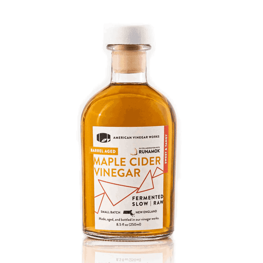 Alt Text: The front view of a bottle of American Vinegar Works Maple Cider Vinegar, made in collaboration with Runamok, featuring a barrel-aged label against a clean white background.