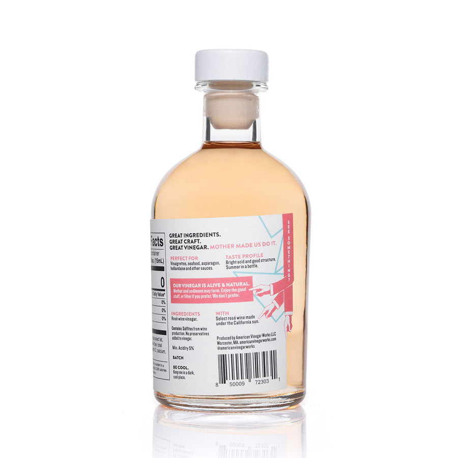 Alt Text: A detailed back view of a bottle of American Vinegar Works Pink Pacific Rosé Wine Vinegar, showing the nutrition facts, product details, and a taste profile featuring bright acid and select rosé wine under the California sun.