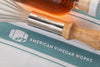 whisk and towel vinegar close up