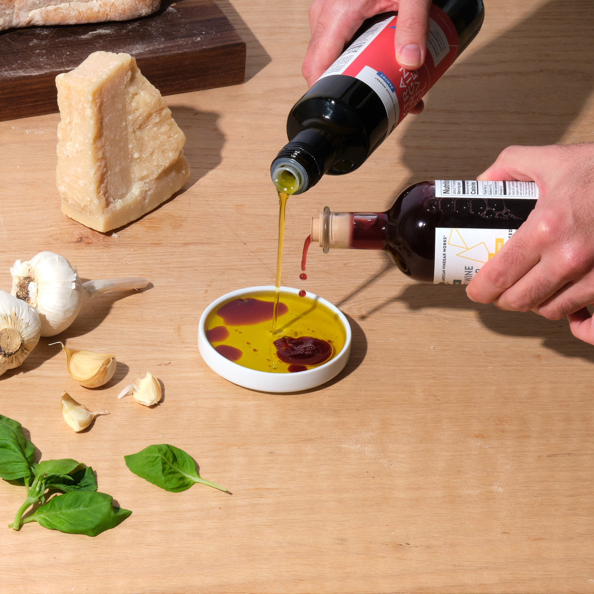 Pouring California Organic Extra Virgin Olive Oil and vinegar into a dish