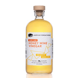 Barrel Aged honey wine vinegar bottle in a 1L size, front view on a white background