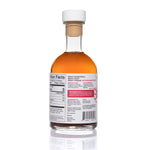 Back view of Cranberry Apple Cider Vinegar: white cap and rich, deep-toned liquid.