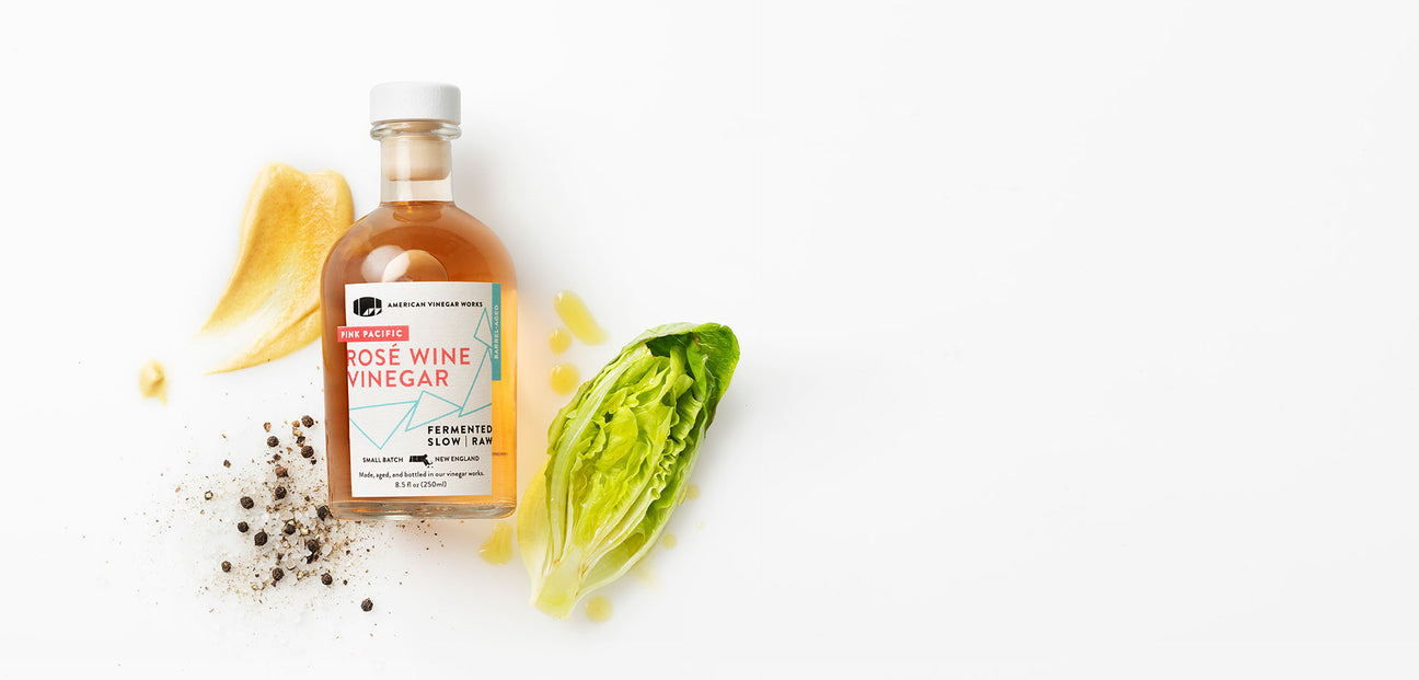 Rose wine Vinegar with vegetables in a white background