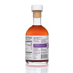 Back view of 8.5oz Blueberry Apple Cider Vinegar: deep red liquid, white/purple/pink label on white