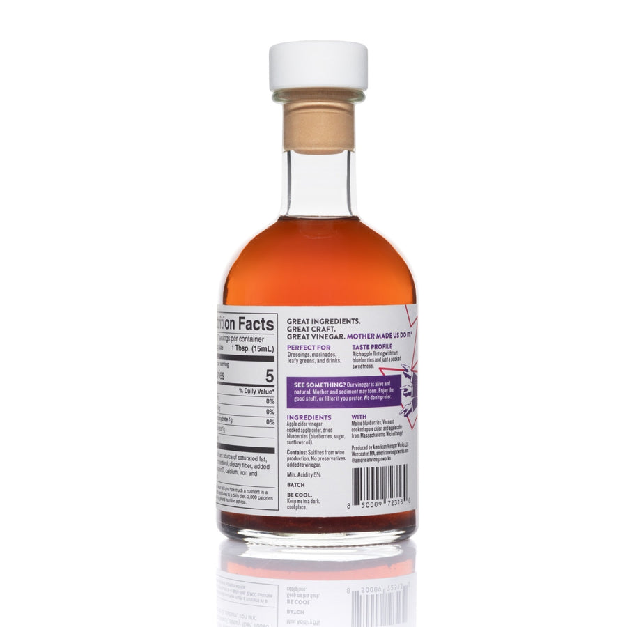 Back view of 8.5oz Blueberry Apple Cider Vinegar: deep red liquid, white/purple/pink label on white
